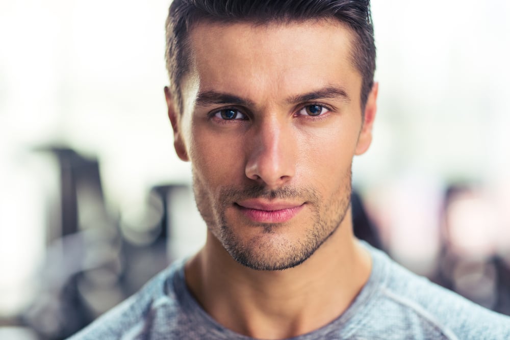 Closeup portrait of a handsome man at gym